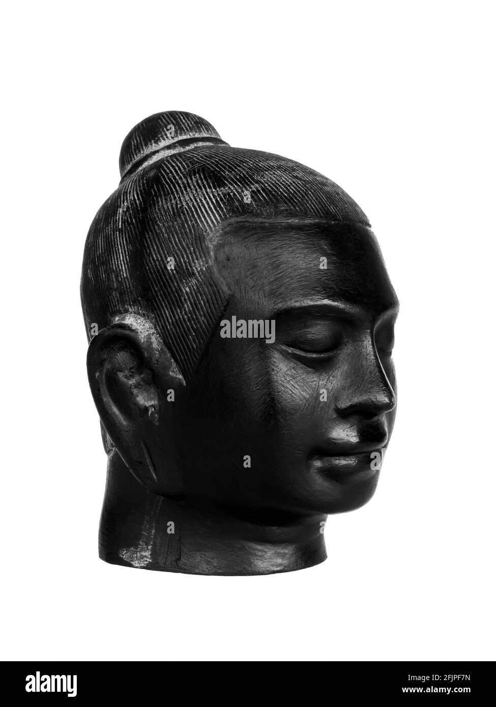 Kopf des Buddha, schwarze Farbe aus Stein geschnitzt isoliert auf weißem Hintergrund, vertikalen Stil. Das Gesicht des antiken Stein buddha, Seitenansicht. Stockfoto