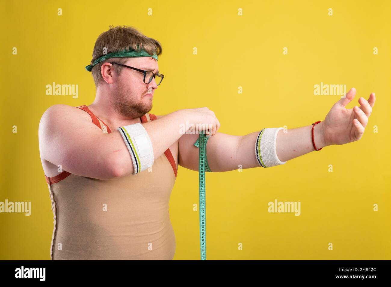 Lustige fette Mann in Sportbekleidung misst das Volumen seiner Arm  Stockfotografie - Alamy