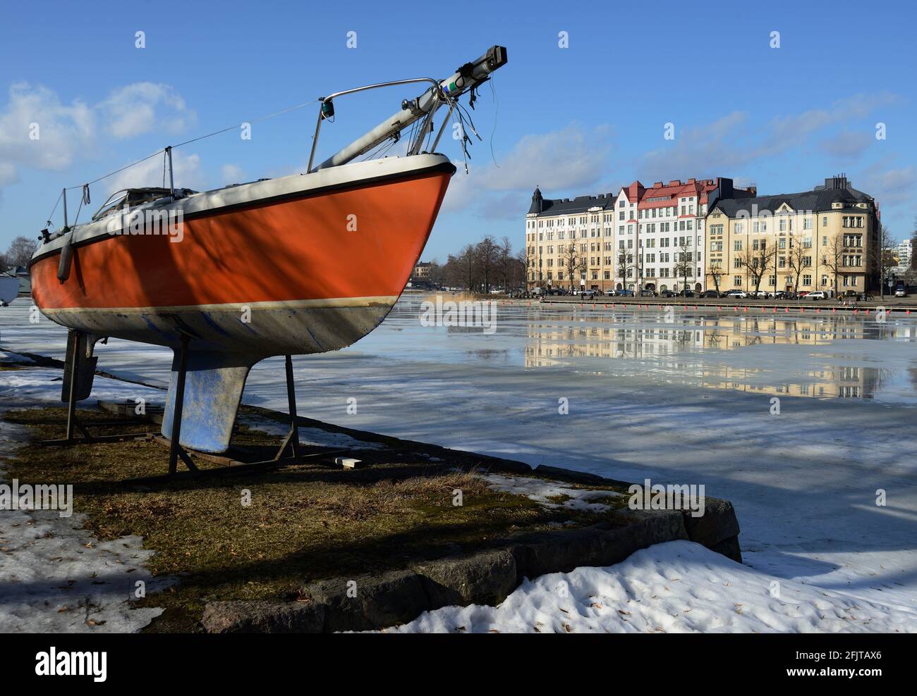 Boot am Ufer der Bucht mit schmelzendem Eis in Helsinki, Finnland Stockfoto