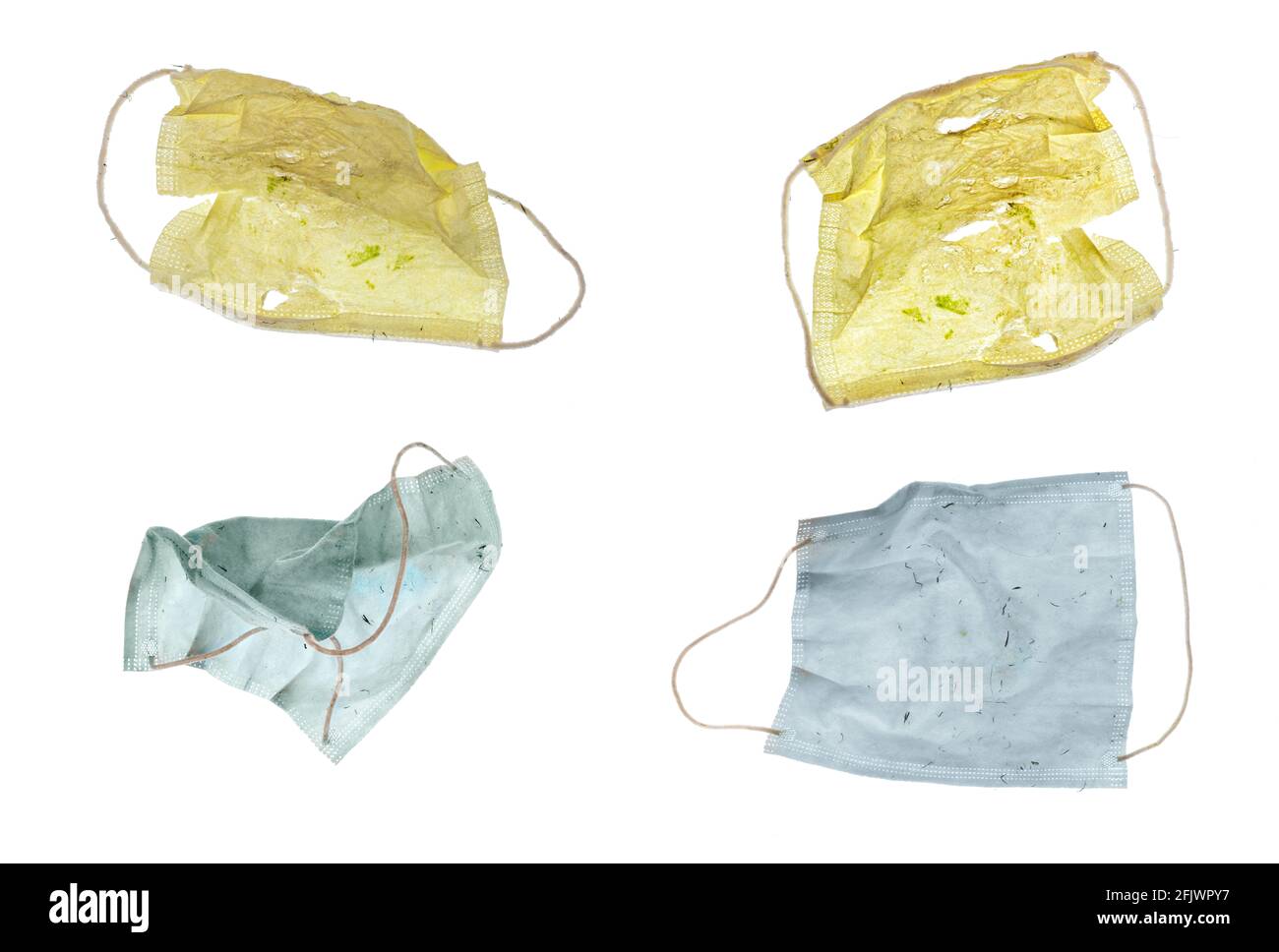 Vier farbige Covid-Papiermasken bereit für den Müll, isoliert auf weiß für Ihre einfache Extraktion. Stockfoto
