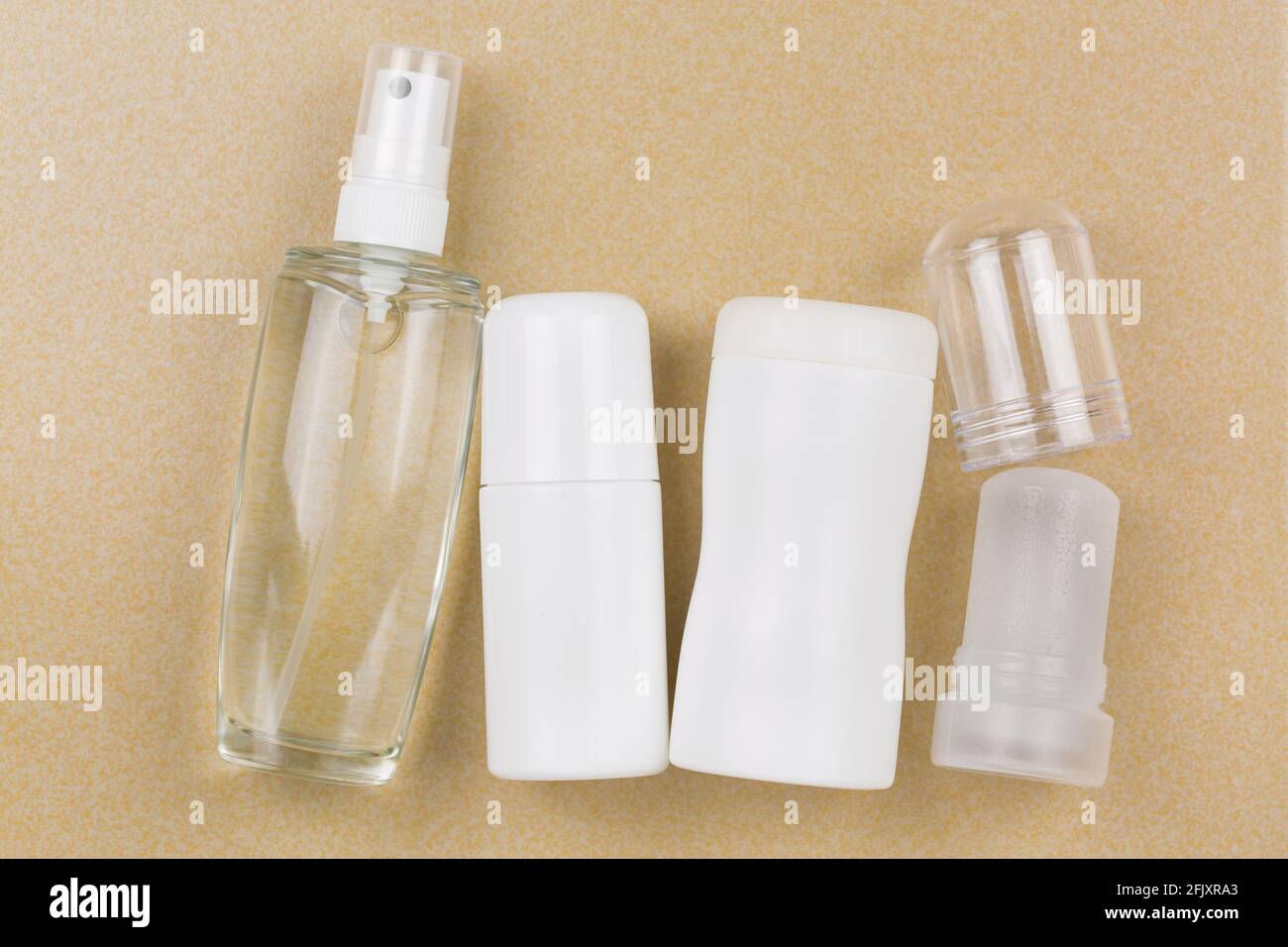 Deodorant Spray, Roll-on, Pulver, Mineral-Alaun-Kristall-Stick. Antitranspirant-Produkte im Achselbereich ohne Aluminiumsalz auf gelbem Fliesenboden Stockfoto