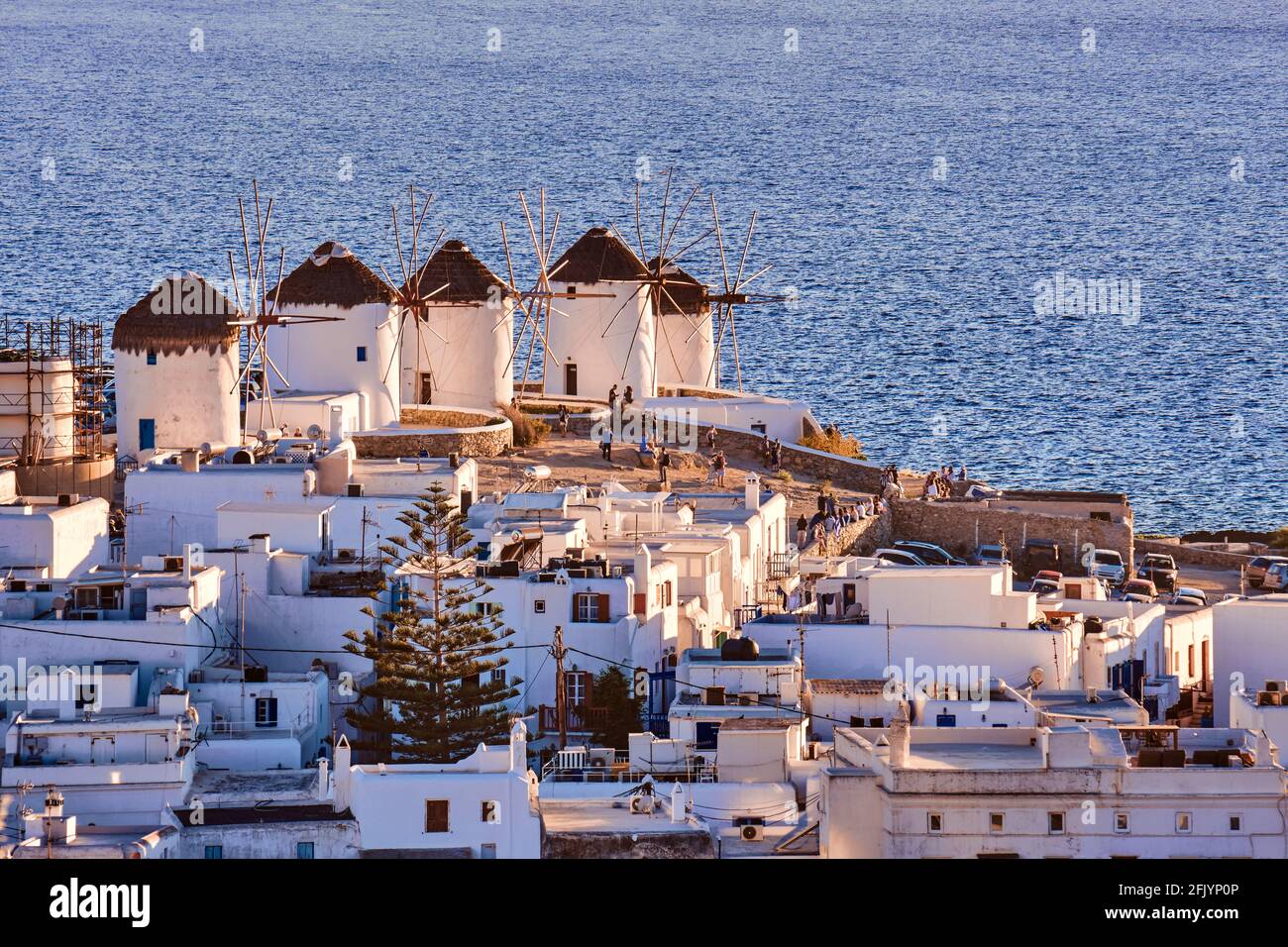 Wunderschöne Aussicht auf die berühmten traditionellen weißen Windmühlen auf dem Hügel, Mykonos, Griechenland. Weiß getünchte Häuser, trübe Sommerabende, ikonisches Ziel Stockfoto