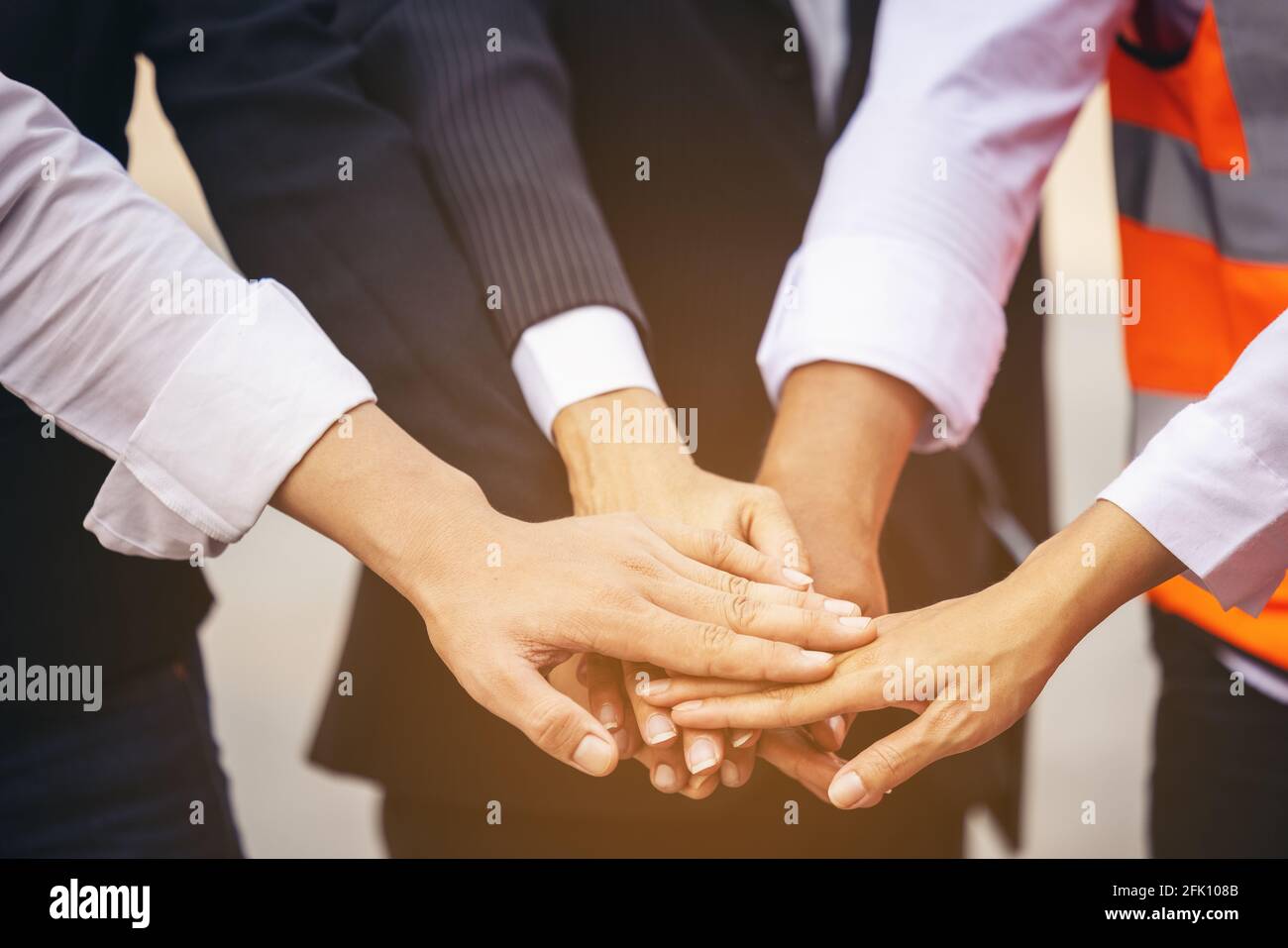 Unity and Success Concept.Bottom view of Engineer Team People Standing Hands Holding together at the Container Yard. Stockfoto