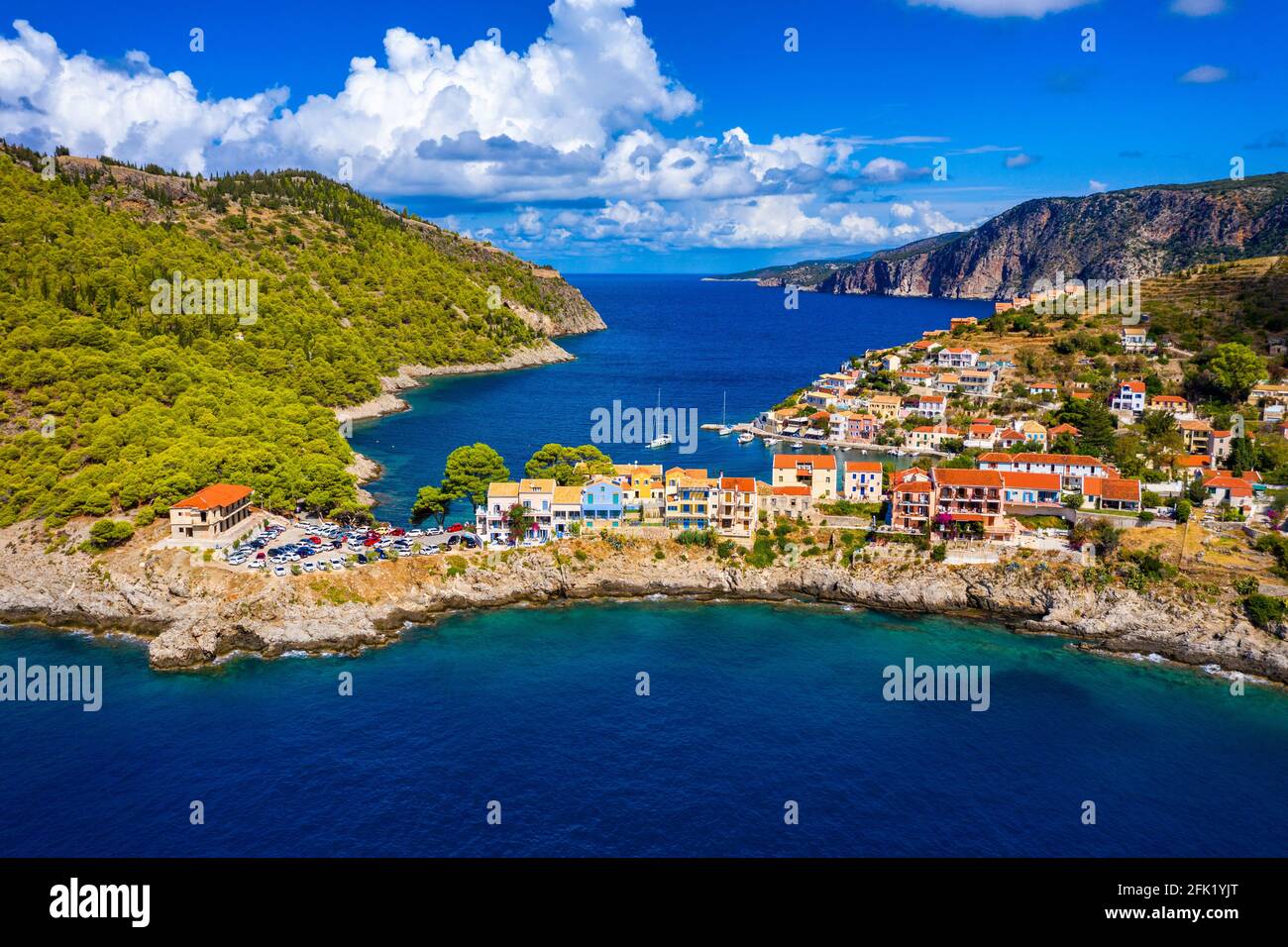 Türkisfarbene Bucht im Mittelmeer mit schönen bunten Häusern in Assos Dorf in Kefalonia, Griechenland. Stadt Assos mit bunten Häusern Stockfoto