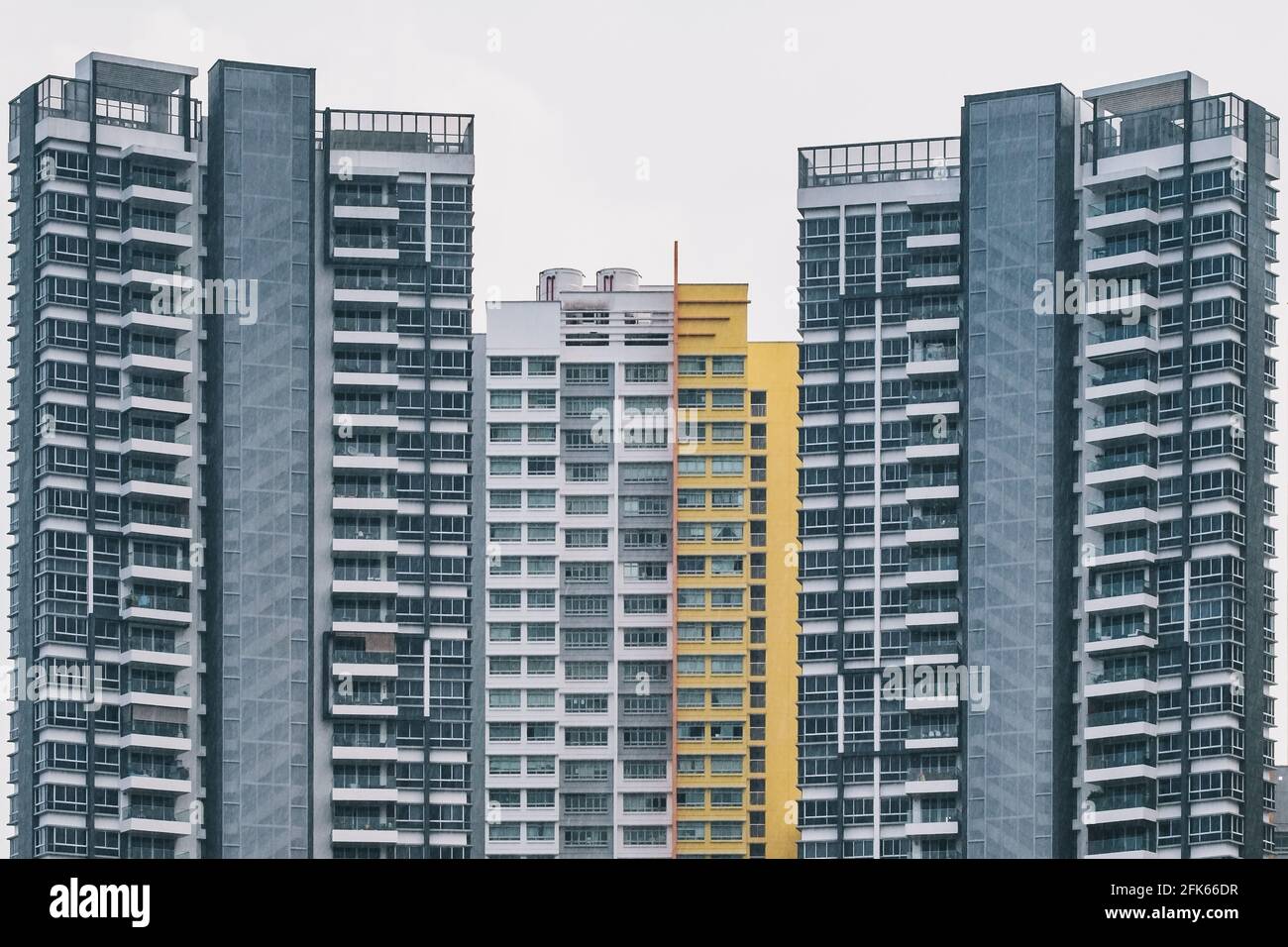 Vorderansicht eines alten, dichten Apartmentkomplexes mit Außenansicht in Singapur regnet es in stimmungsvollen Tönen Stockfoto