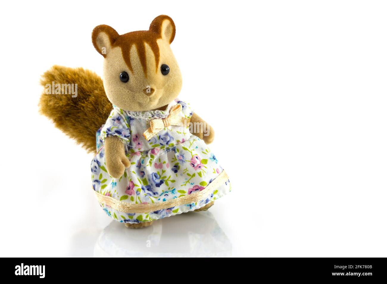 Mädchen Eichhörnchen Spielzeug trägt Kleid auf weißem Hintergrund Stockfoto