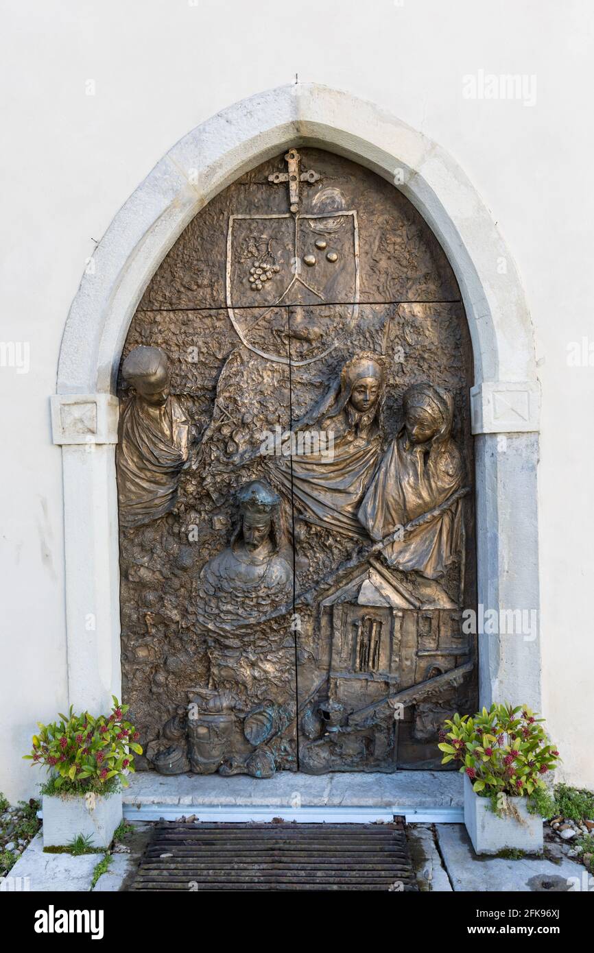 Holztür mit einem Bronzerelief bedeckt, St. Nikolaus Kathedrale in Novo mesto, Slowenien Stockfoto