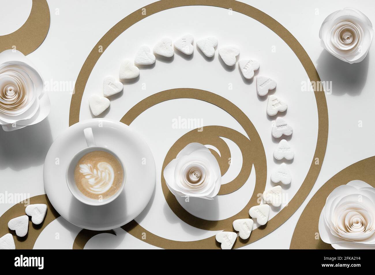 Kaffeetasse, Fibonacci Sequence Kreise aus braunem Papier und Zuckerherzen. Latte Art mit floralem Design, leckerer Perfektion. Golden Ratio-Konzept Stockfoto