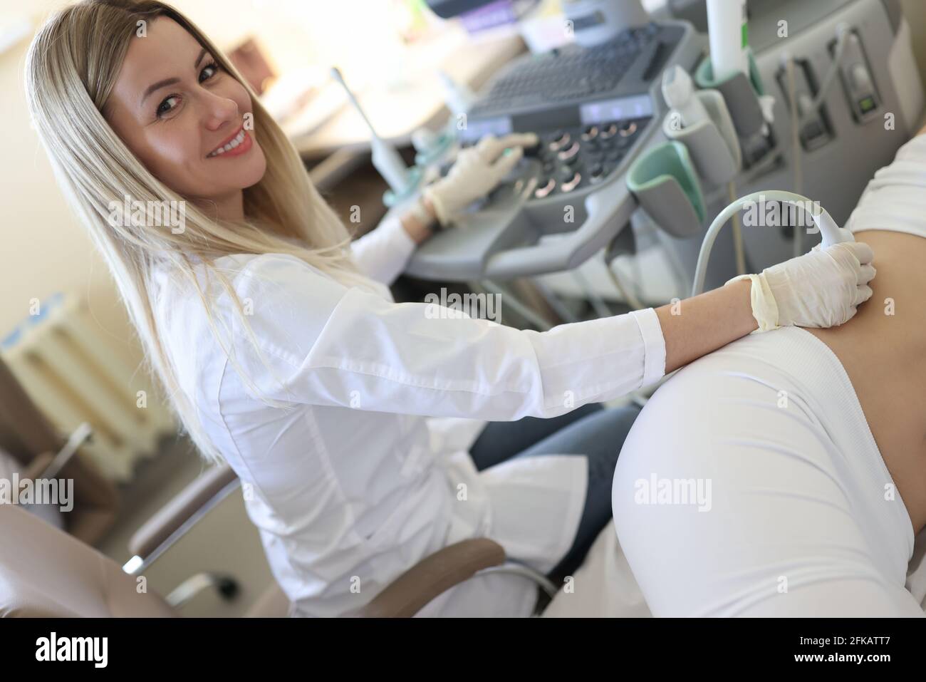 Ärztin, die Ultraschalluntersuchung der Nieren bei einer Patientin macht In der Klinik Stockfoto