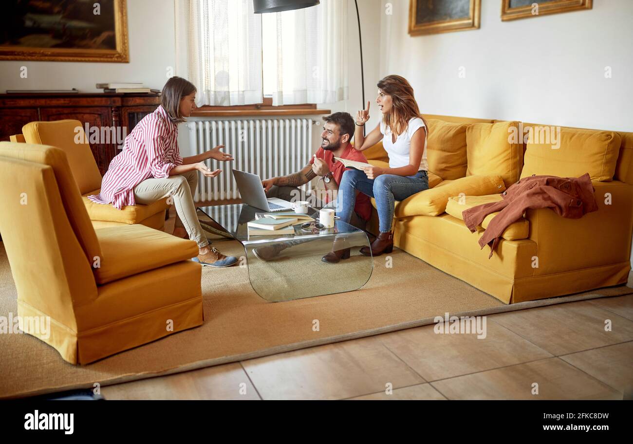 Grop von fröhlichen Studenten, die sich zu Hause auf die Prüfung vorbereiten Stockfoto