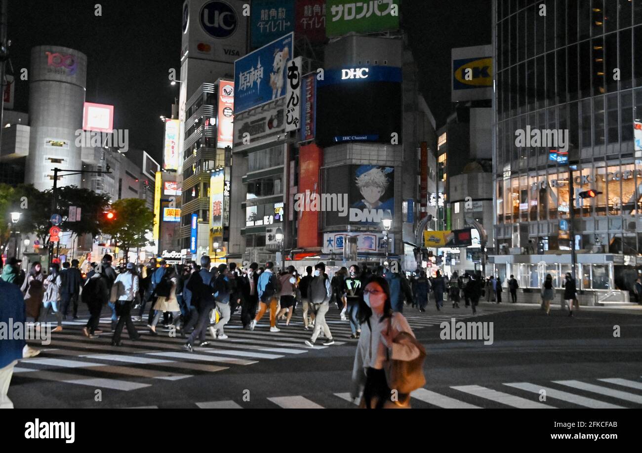 Tokio, Japan. April 2021. Fußgänger, die Gesichtsmasken tragen, gehen am Freitag, den 30. April 2021, am Shibuya-Übergang in Tokio, Japan, spazieren. Der Gouverneur von Tokio, Yuriko Koike, fordert während des dritten Ausnahmezustands für COVID-19 vom 25. April bis 11. Mai, die Neonschilder nach 8 Uhr auszuschalten. Foto von Keizo Mori/UPI Credit: UPI/Alamy Live News Stockfoto