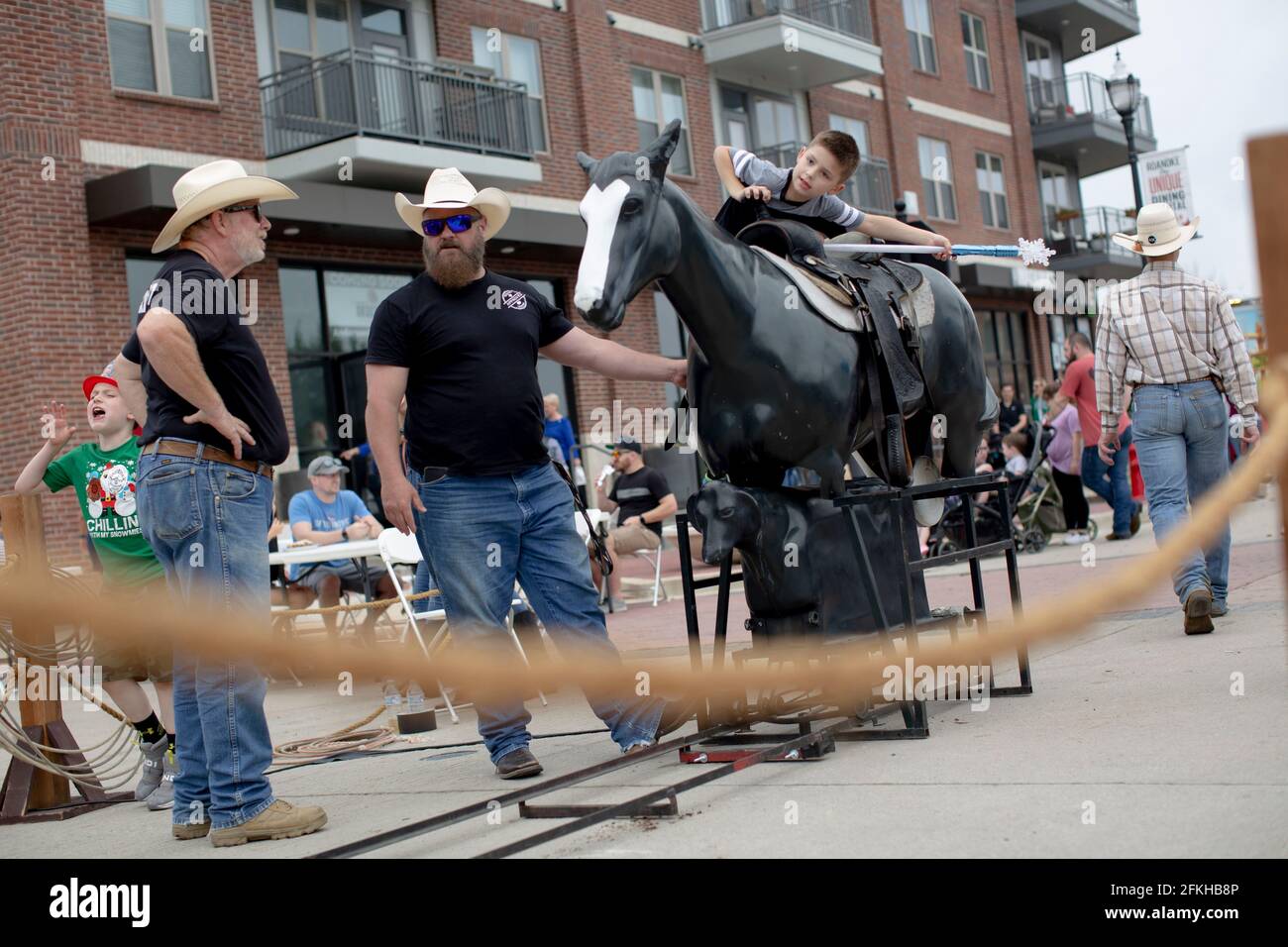 Roanoke, Texas, USA. Mai 2021. 5/1/21 Roanoke, Texas - EIN Kind springt auf ein gefälschtes Pferd, um beim 5. Roanoke Roundup fotografiert zu werden. Dies ist eine der ersten öffentlichen Messen, die seit der Öffnung von Texas zu 100 % stattgefunden haben, seit die COVID-19-Pandemie den Staat getroffen hat. Quelle: Chris Rusanowsky/ZUMA Wire/Alamy Live News Stockfoto