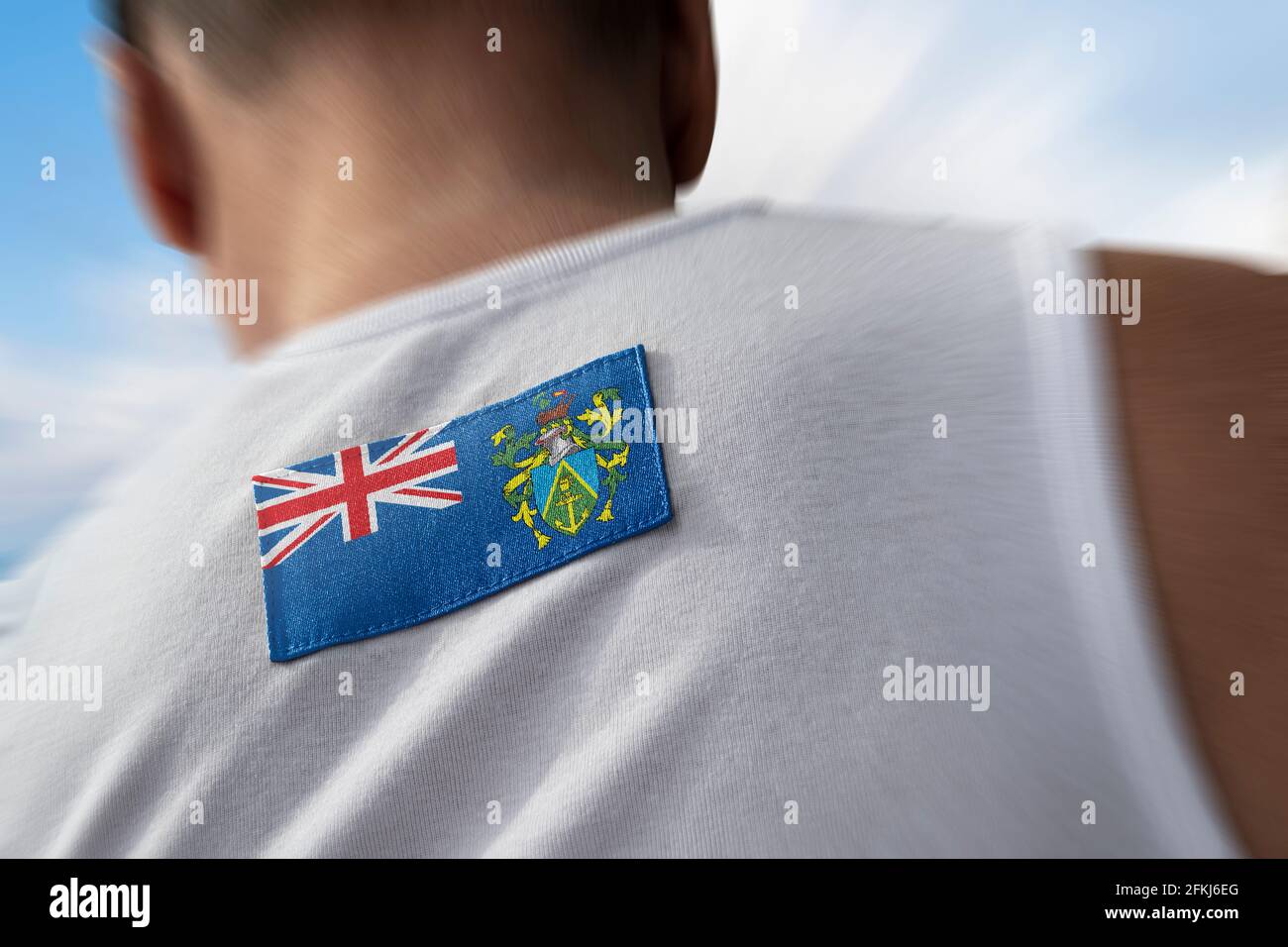 Die Nationalflagge der Pitcairninseln auf dem Rücken des Athleten Stockfoto