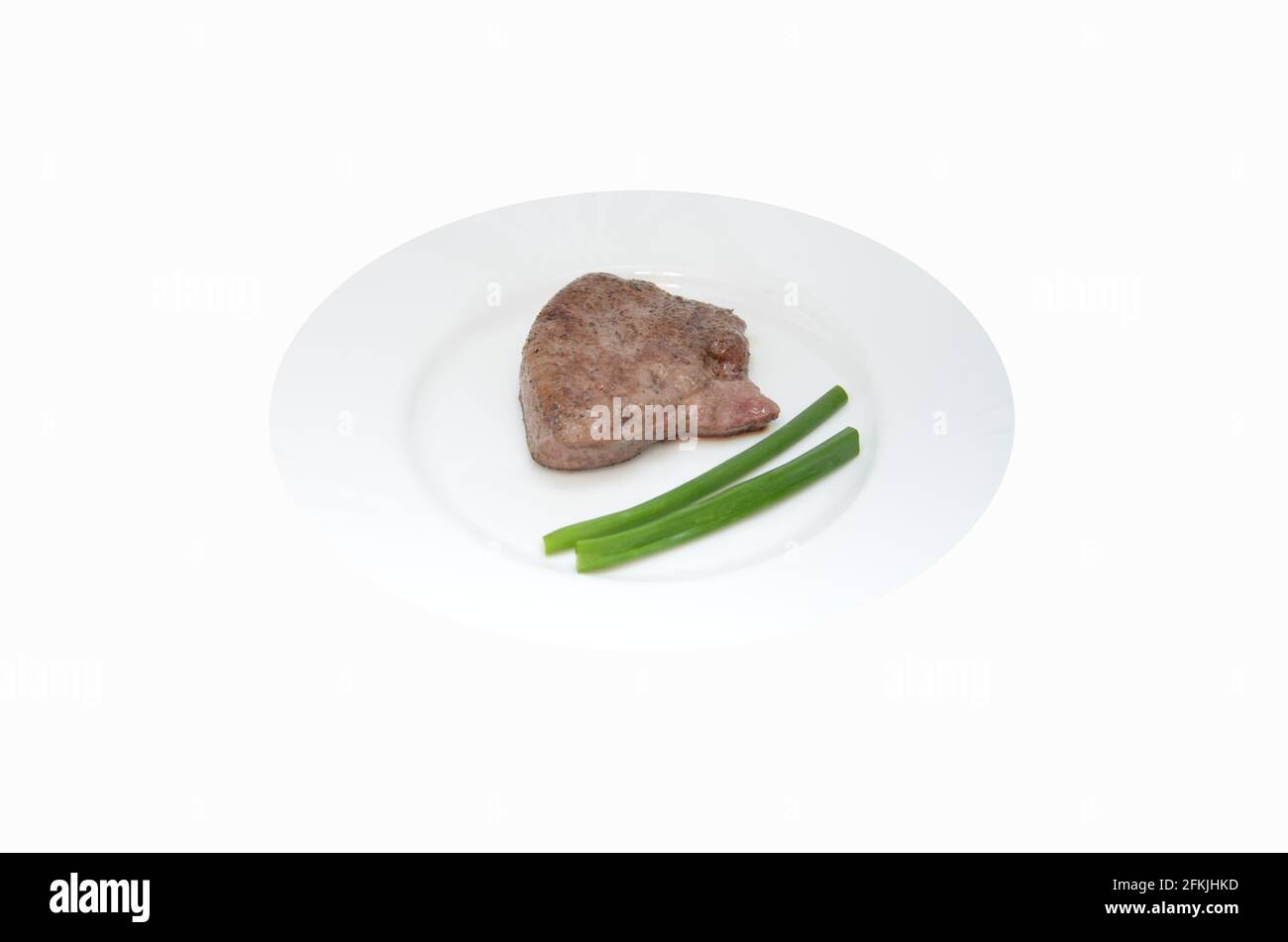 Kalbsleber auf einem weißen Teller, Leber garniert mit grünen Zwiebeln, einem appetitlichen Stück Rinderleber Stockfoto