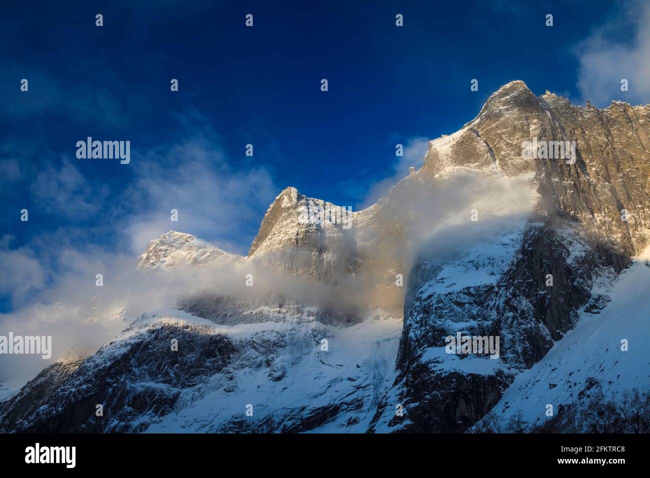 Frühmorgens goldene Stunde Sonnenlicht auf verschneiten Bergen im Romsdalen Tal, Rauma kommune, Møre Og Romsdal, Norwegen, Skandinavien. Stockfoto