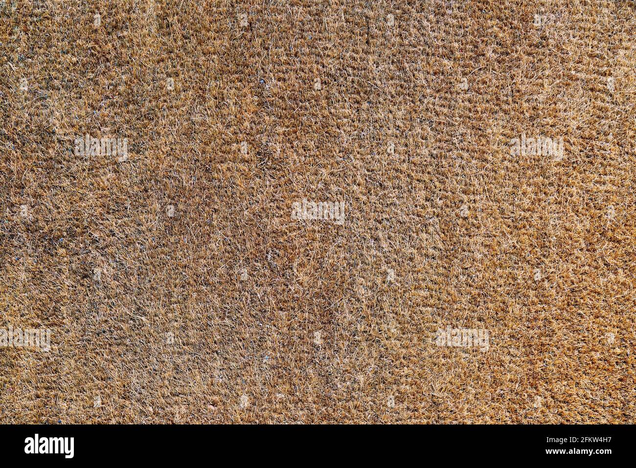 Die Textur einer alten und abgenutzten Coir-Fußmatte Stockfoto