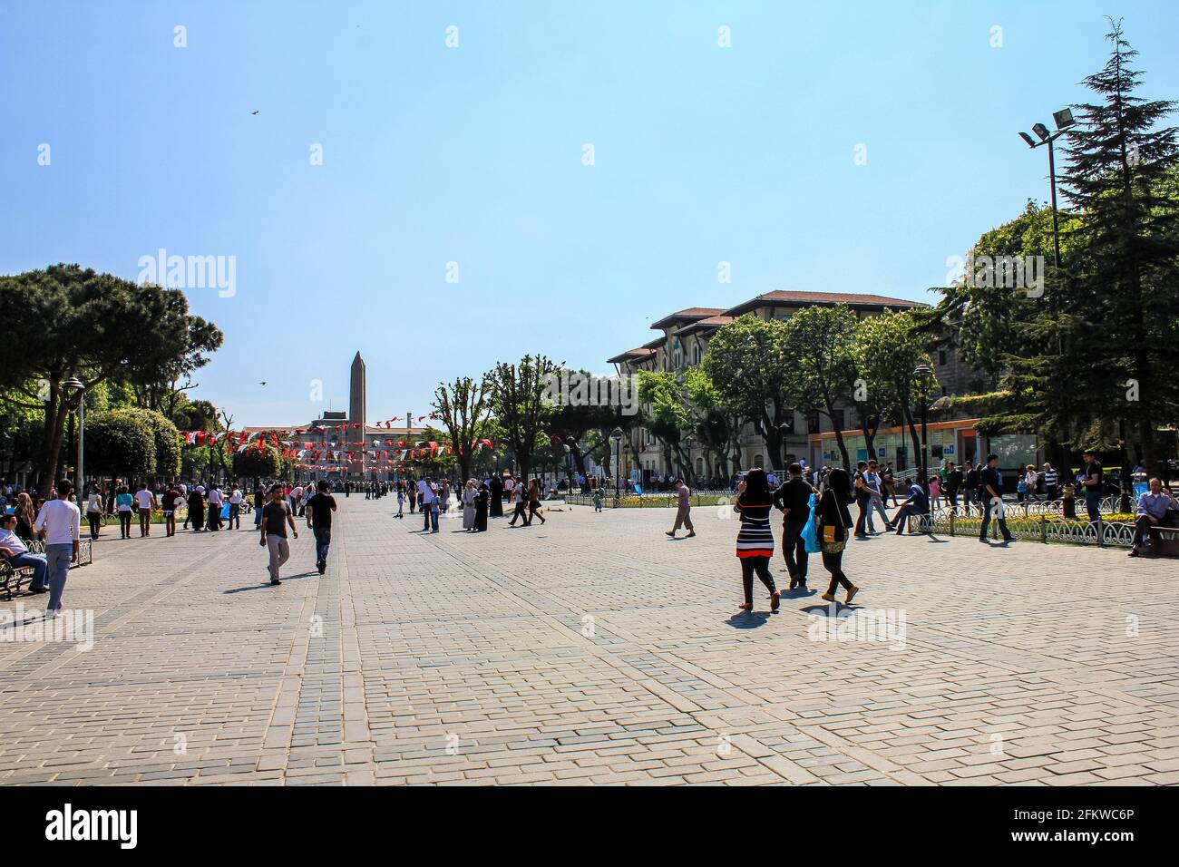 Istanbul, Türkei - 12. Mai 2013: Menschen, die im antiken Hippodrom mit Obelisk im Hintergrund spazieren Stockfoto