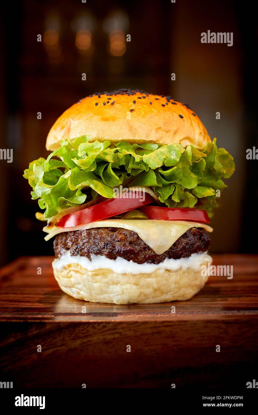 Leckerer Käseburger auf Holztisch Stockfoto