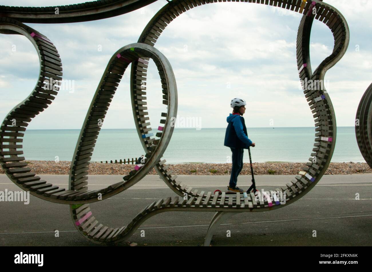 Junge spöttisch vorbei an der langen Bank Littlehampton West Sussex Stockfoto