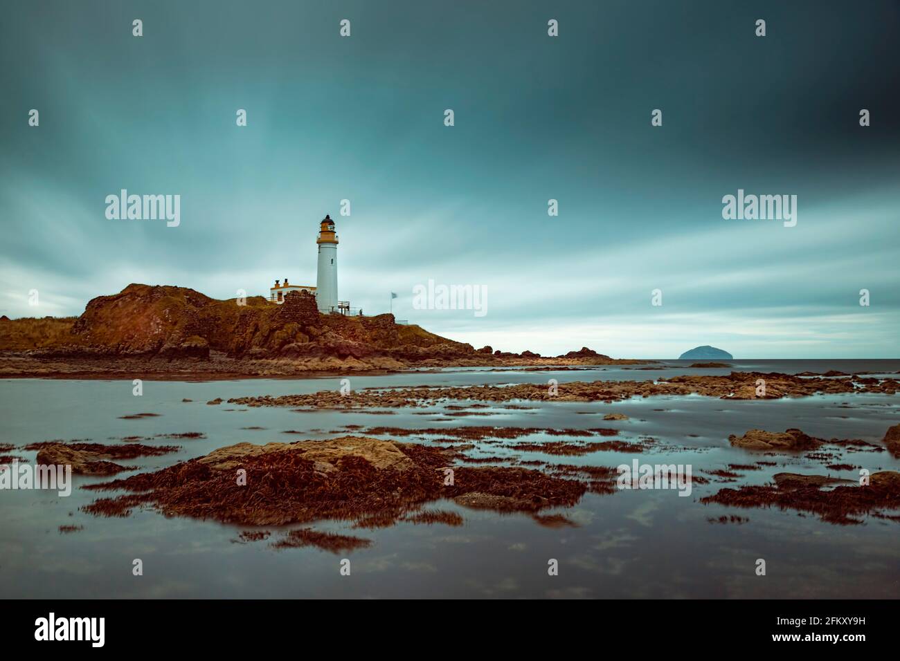 Langzeitbelichtung des Turnberry Lighthouse auf dem berühmten Golfplatz in Schottland von den Felsen bei Ebbe. Stockfoto