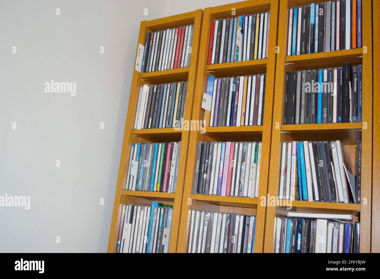 CD-Schrank voll mit cds in alphabetischer Reihenfolge. Stockfoto