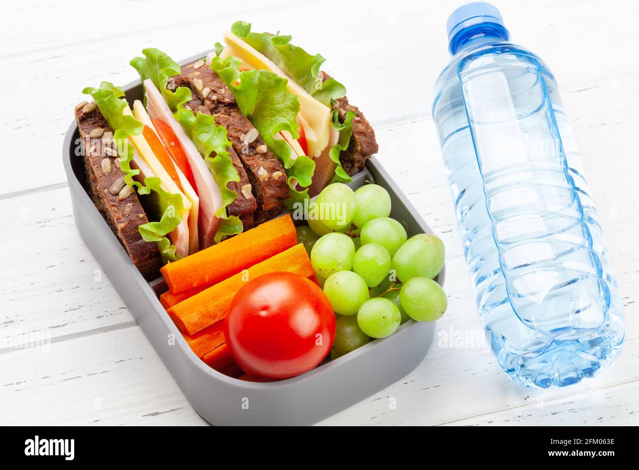 Gesunde Lunchbox für die Schule mit Sandwich und frischem Gemüse, Wasserflasche Stockfoto