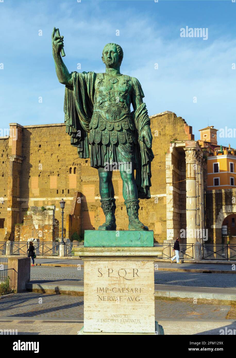 Rom, Italien. Statue des Imperators Nerva mit Trajans Forum dahinter. Das historische Zentrum von Rom ist ein UNESCO-Weltkulturerbe. Stockfoto