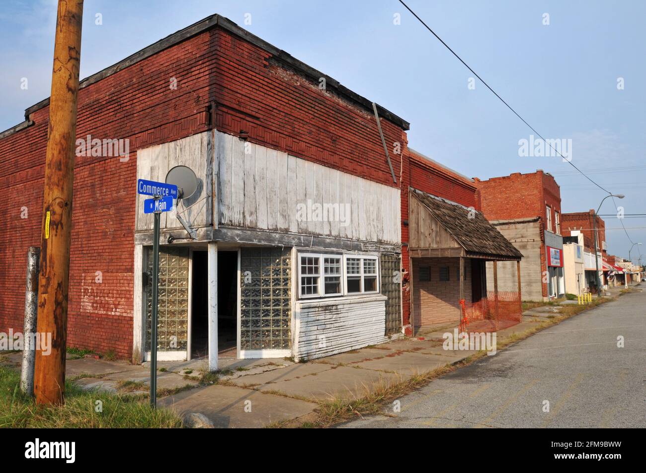 Historische Backsteingebäude und Geschäftshäuser säumen die ruhige Hauptstraße der Route 66 City of Commerce, Oklahoma. Stockfoto