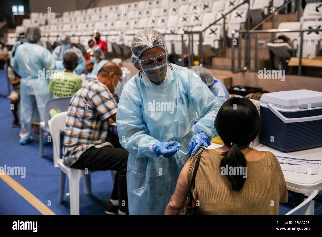 Im Makati Coliseum in der Metropole Manila impfen Gesundheitshelfer Einwohner mit dem russischen Impfstoff Sputnik V COVID-19. Die Philippinen erhielten die ersten 15,000 Dosen von Sputnik V, die vom russischen Gamaleya-Institut entwickelt wurden, und wurden in vier Städten der Hauptstadtregion für ein gleichzeitiges Impfprogramm verteilt. Manila, Philippinen. Stockfoto