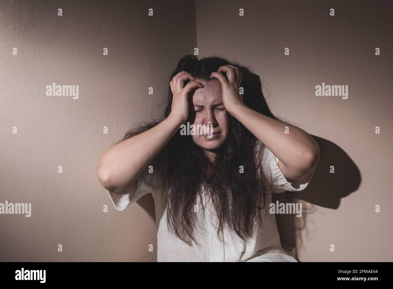 Junge Frau, die nach Covid-19 an einer schweren Depression und Angst, psychiatrischem Problem leidet Stockfoto