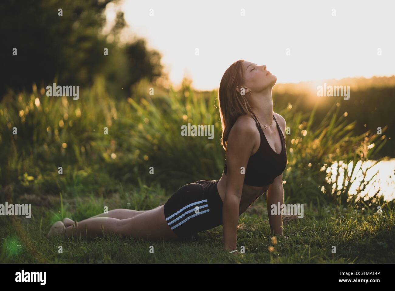 Yoga in der Natur bei den Sonnenuntergängen an einem Teich, Franken, Bayern, Deutschland Stockfoto