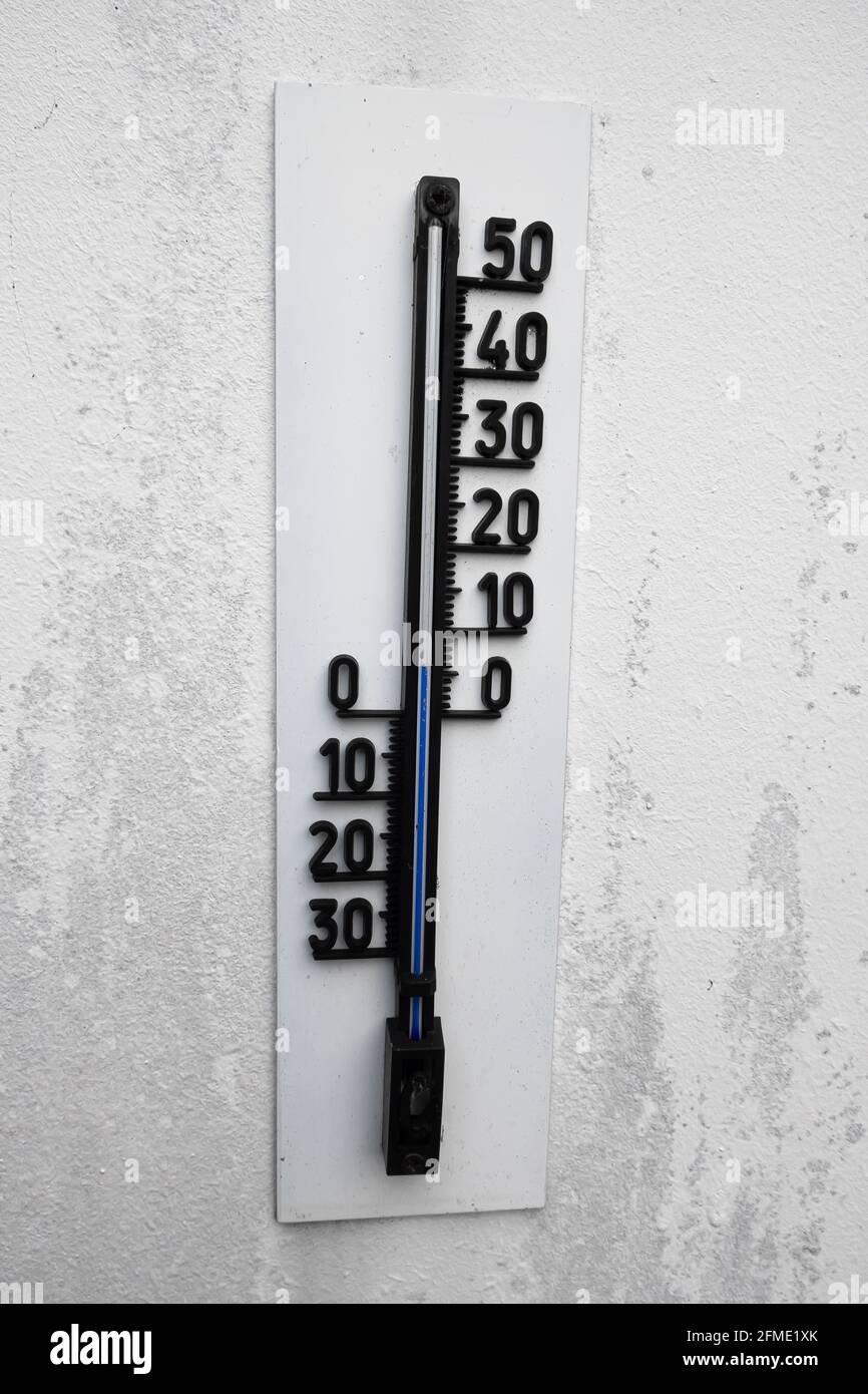Dietikon, Schweiz - 24. November 2020: Das Thermometer an der Wand zeigt nur wenige Grad über Null Stockfoto