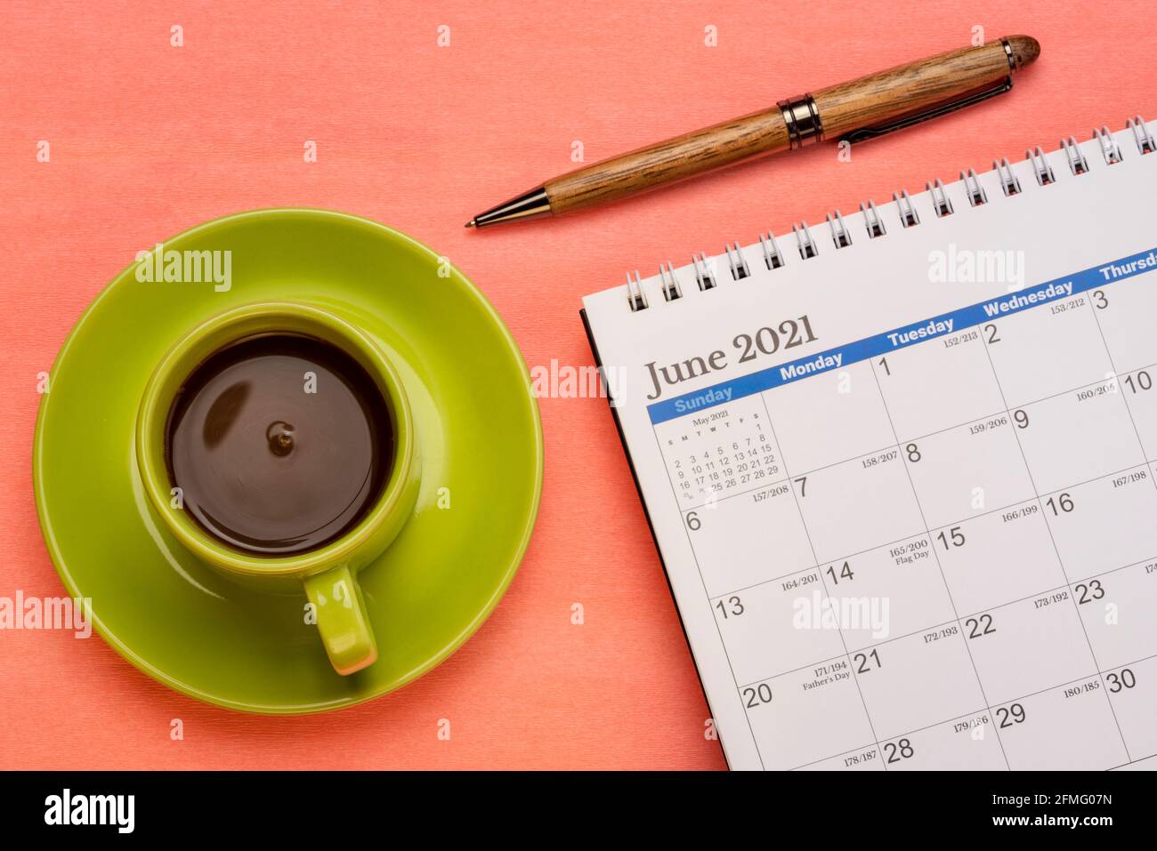 Juni 2021 - Spiral Desktop Kalender mit einem Stift und Tasse Kaffee flach Lay, Zeit und Business-Konzept Stockfoto