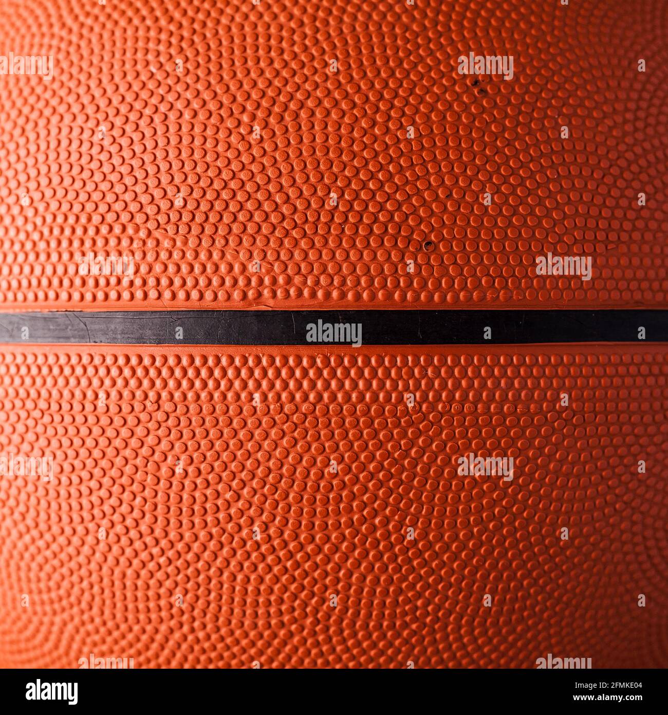 Basketball-Gummi orange Ball Nahaufnahme Textur Hintergrund. Stockfoto