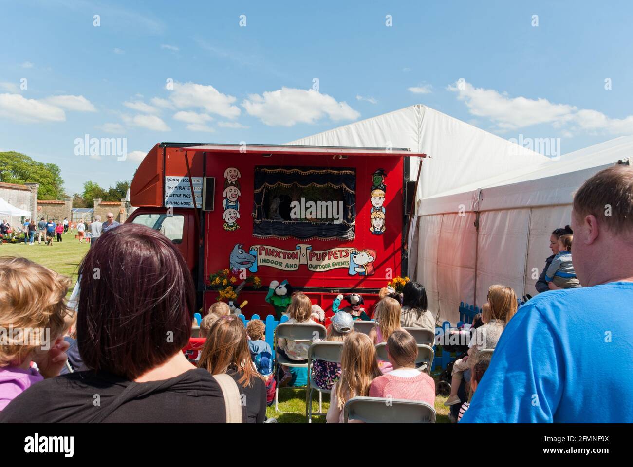 Menschen, die eine Puppentheater im Freien genießen, von Pinxton Puppets, Castle Ashby Country Fair, Northamptonshire, Großbritannien Stockfoto