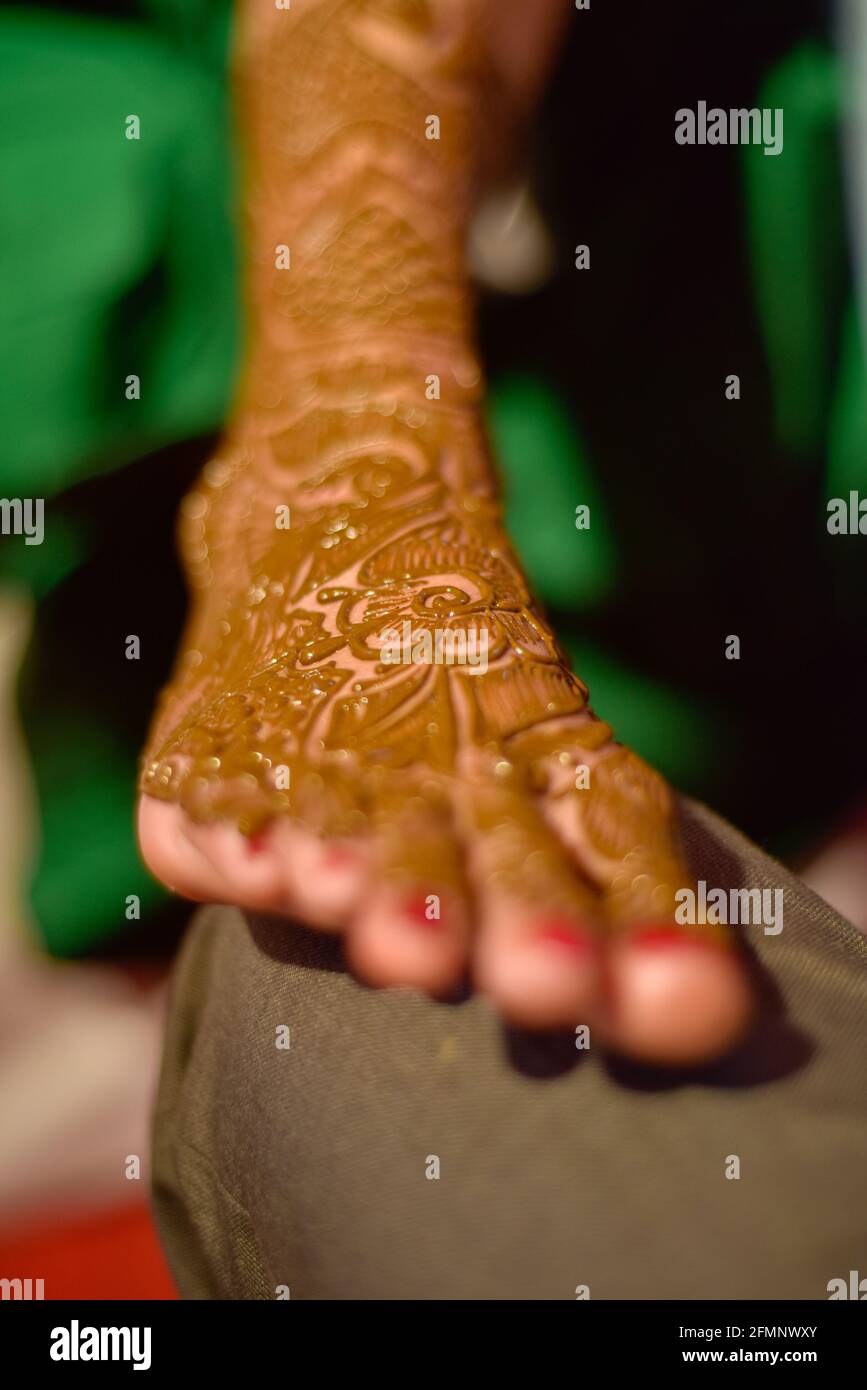 Nahaufnahme der Beine der atemberaubenden indischen Braut, Anwendung hinna auf ihre Hochzeit. Stockfoto