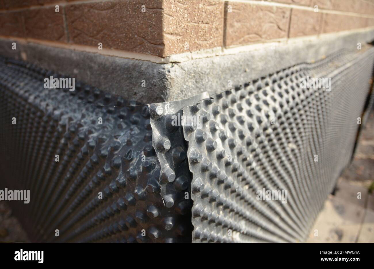 Fundamentabdichtung. Haus Fundament Wand wasserdicht mit Bitumenspray  Stockfotografie - Alamy