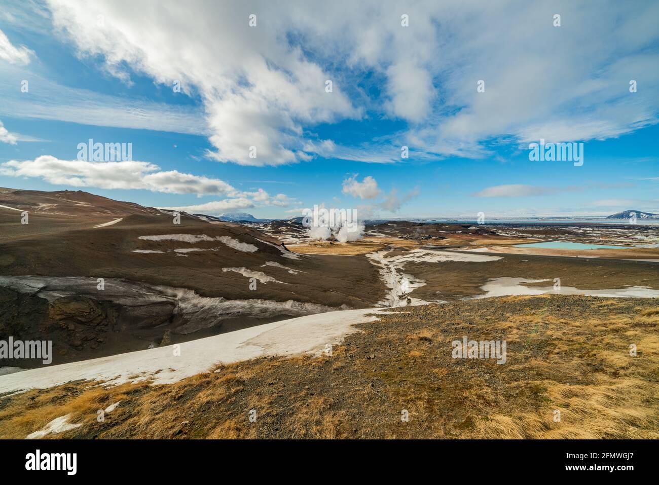 Namafjall Hverir Geothermiegebiet in Island. Atemberaubende Landschaft von Schwefel Tal mit rauchenden Fumarolen und blau bewölkten Himmel, Reise Hintergrund Stockfoto