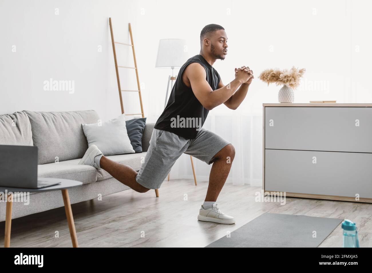 Sportlicher Schwarzer Kerl Macht Einbeinige Squats Online-Training Zu Hause Stockfoto