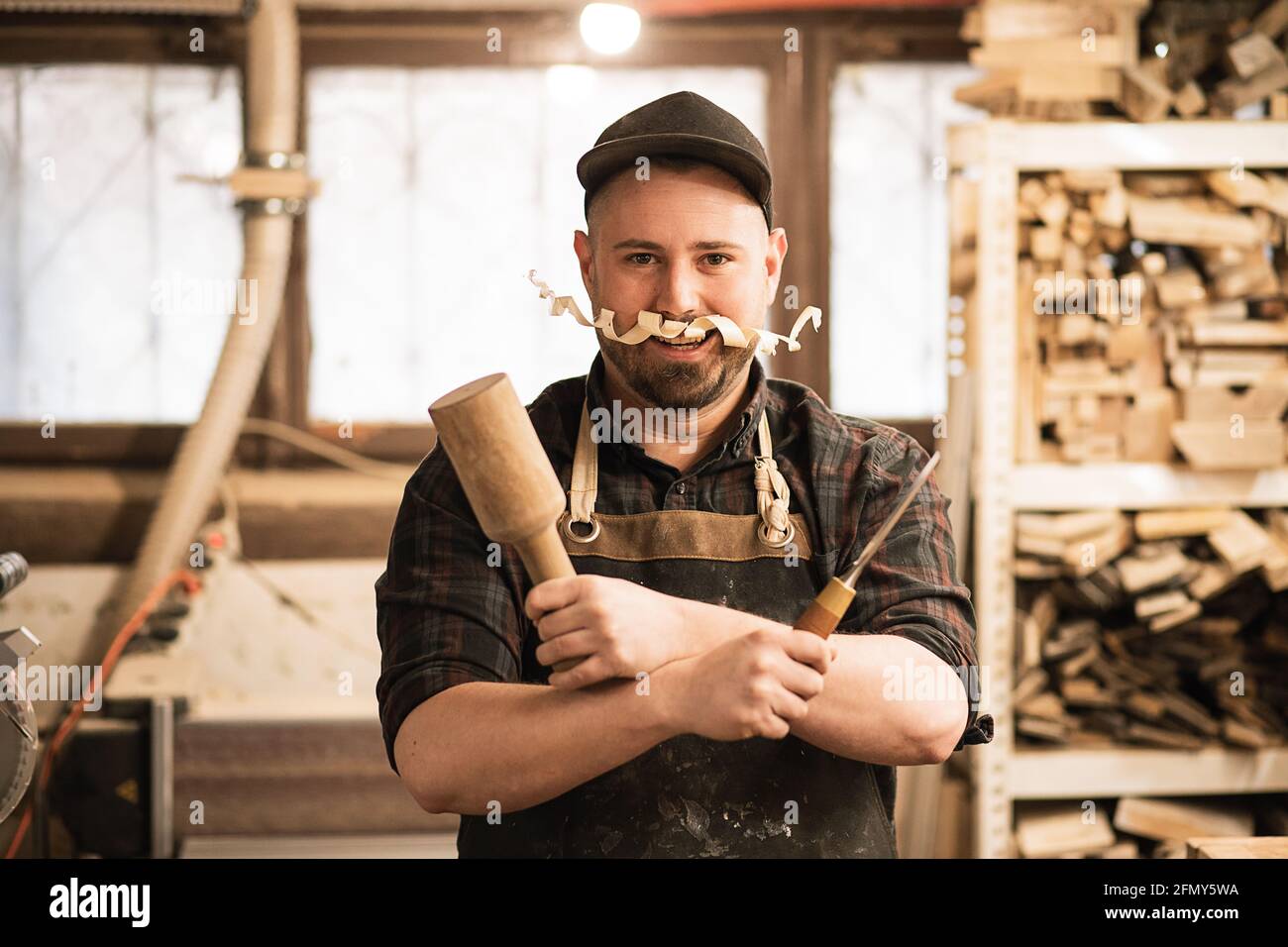 Humor Foto von Zimmermann bei der Arbeit in der Werkstatt mit Schnurrbart Stockfoto