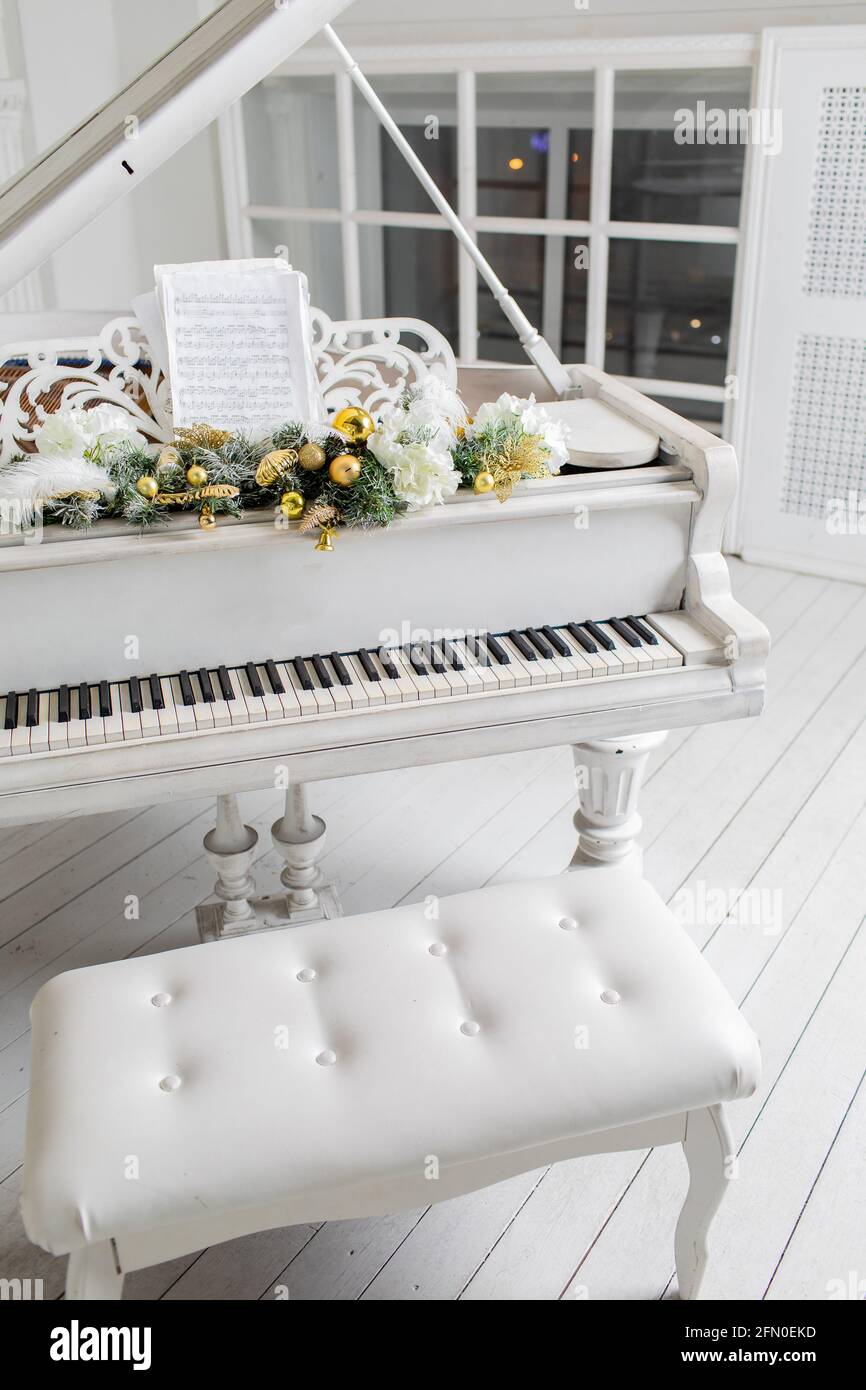 Weißes Klavier in einem weißen Innenraum. Luxuriöse Innenausstattung. Stockfoto