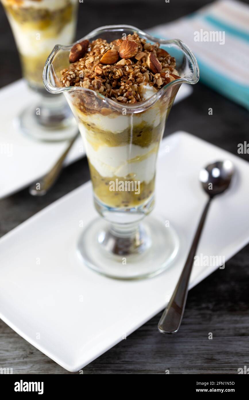 Stachelbeerjoghurt-Töpfe mit Granola-Hafer und Nuss-Belag. Stockfoto