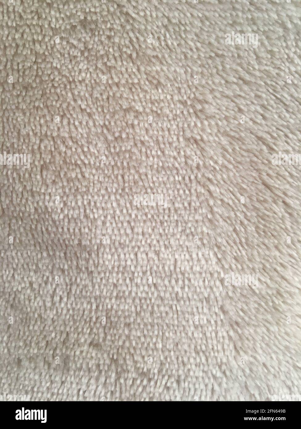 Beigefarbener Plüschstoff mit Textur im Hintergrund Stockfoto