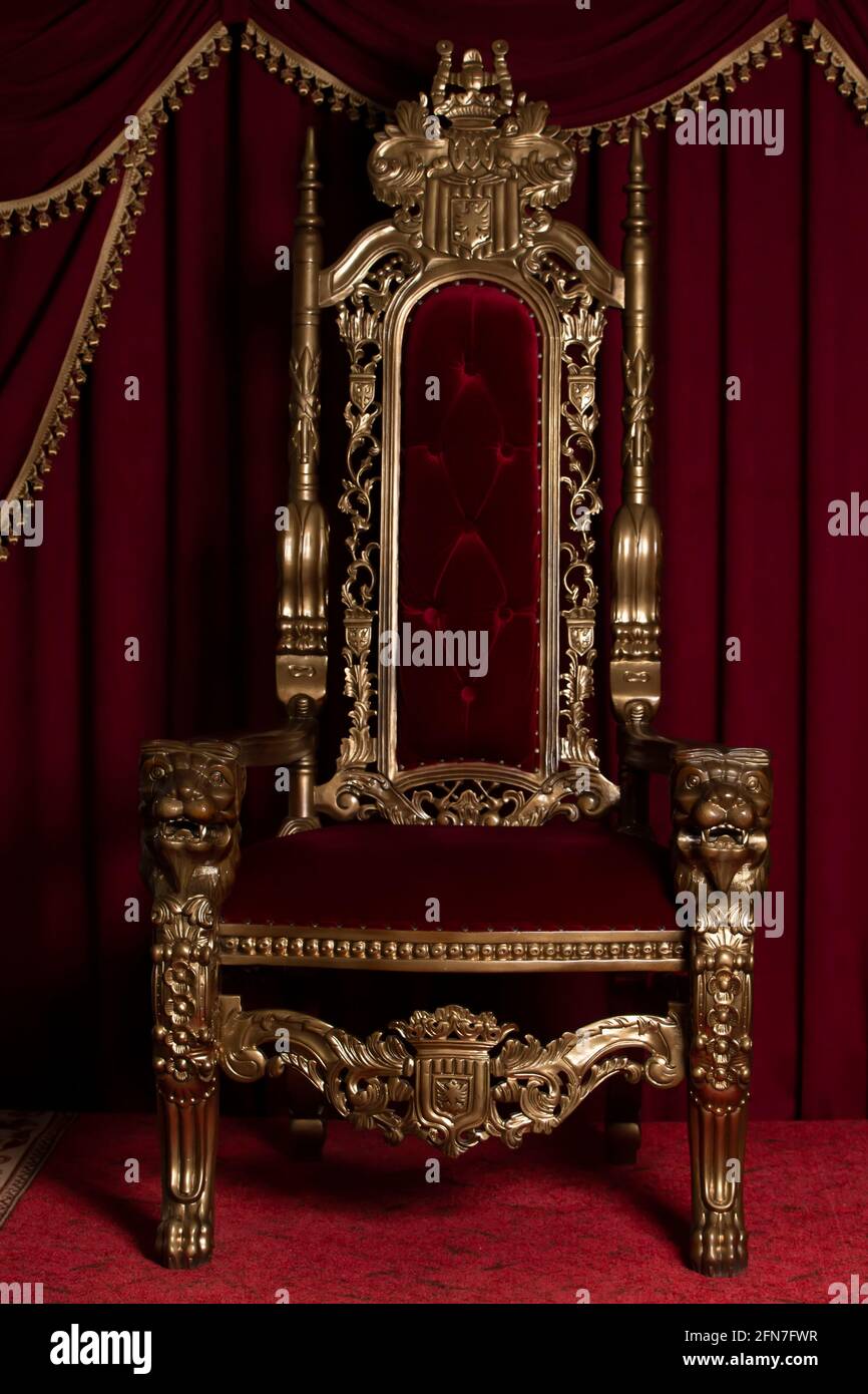 Red Royal Stuhl, auf dem Hintergrund der roten Vorhängen. Platz für den König. Thron Stockfoto