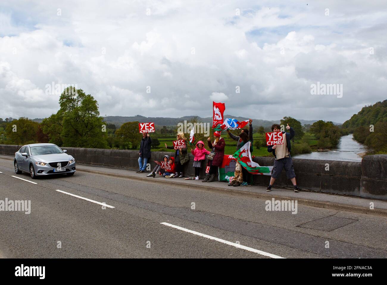 Llandeilo, Carmarthenshire, Wales, Großbritannien. 15. Mai 2021. Anhänger der walisischen Unabhängigkeitsbewegung YesCymru demonstrieren auf der Brücke über den Fluss Tywi in Llandeilo. Kredit: Gruffydd L. Thomas/Alamy Live News Stockfoto