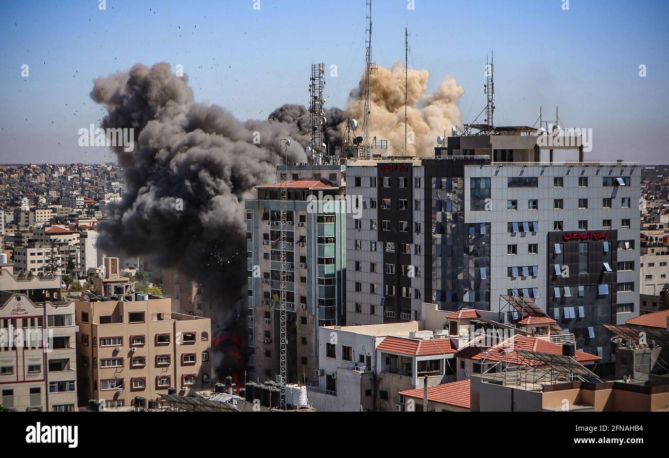 Gazastreifen, Palästina. 15 2021. Mai: Der Rauch steigt, wenn das Gebäude einstürzt, nachdem ein israelischer Luftangriff den Al-Jalaa-Turm getroffen hat, der Wohnungen und mehrere Medien beherbergt, darunter die Associated Press und Al Jazeera, in Gaza-Stadt, 15. Mai 2021. Als Reaktion auf die Tage der gewalttätigen Auseinandersetzungen zwischen israelischen Sicherheitskräften und Palästinensern in Jerusalem starteten verschiedene palästinensische Gruppen von Aktivisten in Gaza seit dem 10. Mai Raketenangriffe, bei denen bis heute mindestens neun Israelis getötet wurden. Nach Angaben des palästinensischen Gesundheitsministeriums, mindestens 139 Palästinenser, darunter 39 Kinder, w Stockfoto