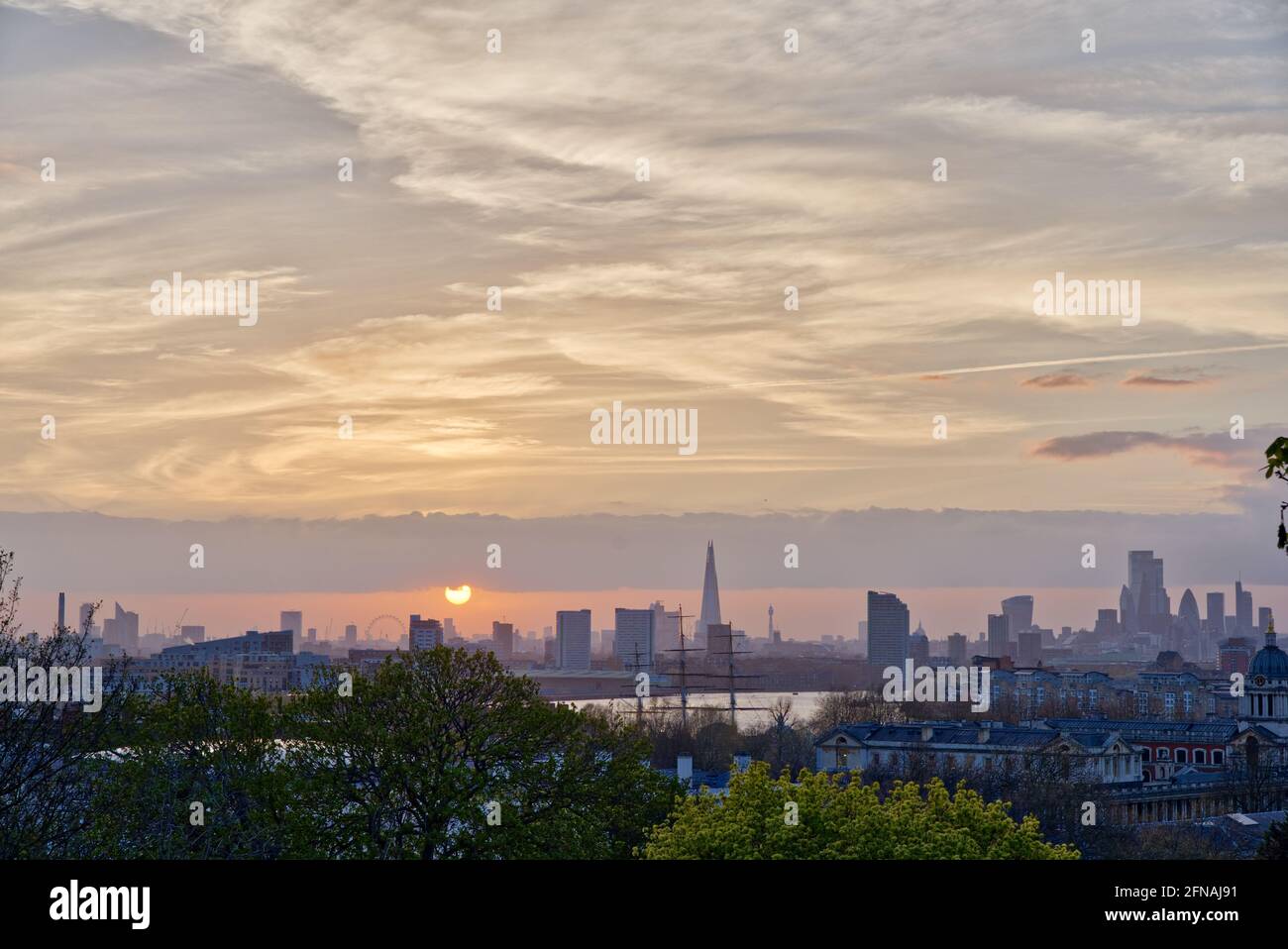 Frühlingsuntergang über den London Skylines von der Themse aus gesehen, Greenwich Stockfoto