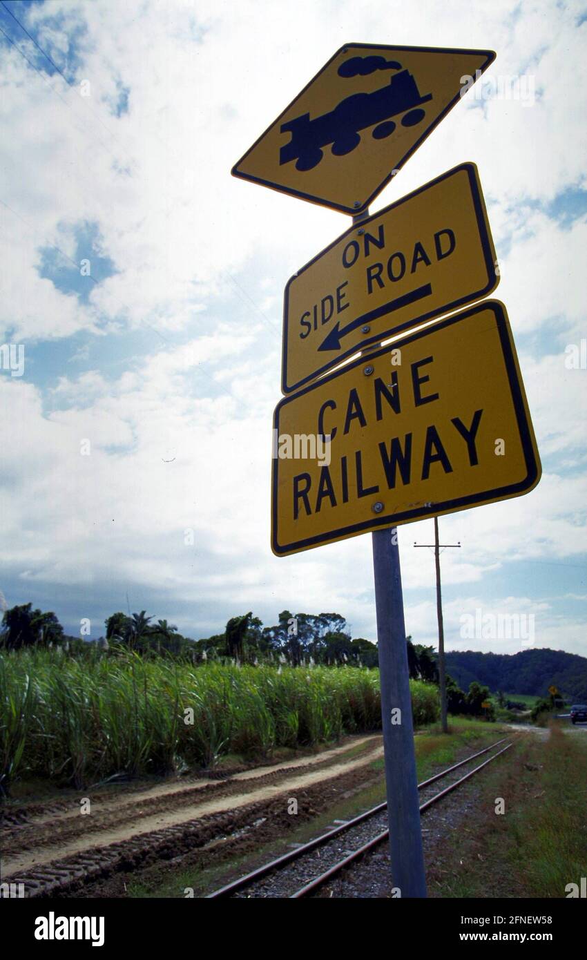 Gleise und Verkehrszeichen der Cane Railway in der Nähe von Cairns. Im Hintergrund eine Zuckerrohrplantage. [Automatisierte Übersetzung] Stockfoto