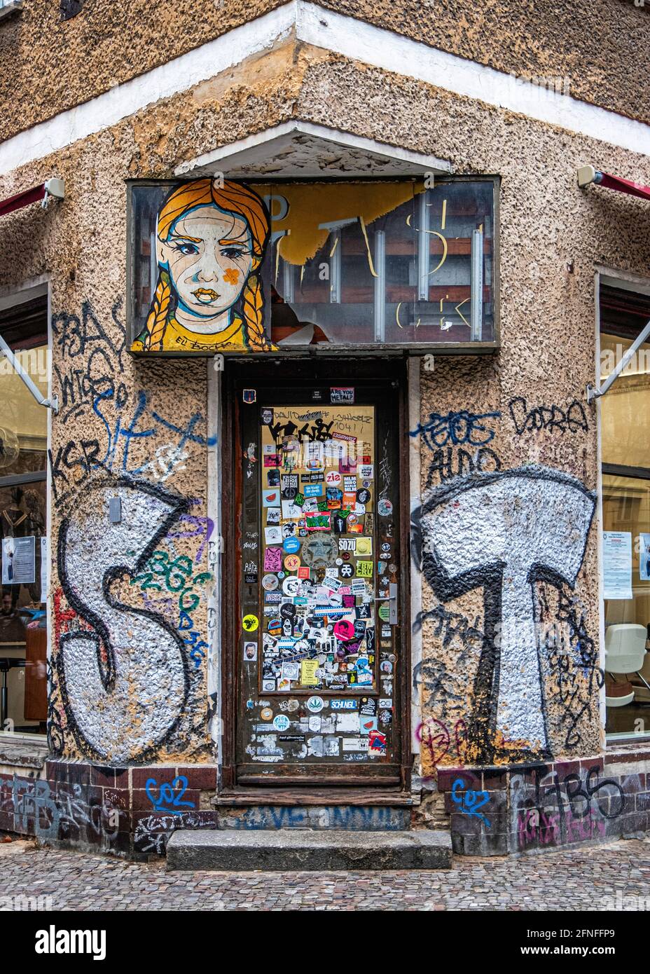 Graffiti-überdachtes Gebäude mit El Bocho-Kunstwerken und Stickerbedeckter Tür, Gethsemanestraße 1, Prenzlauer Berg, Berlin Stockfoto