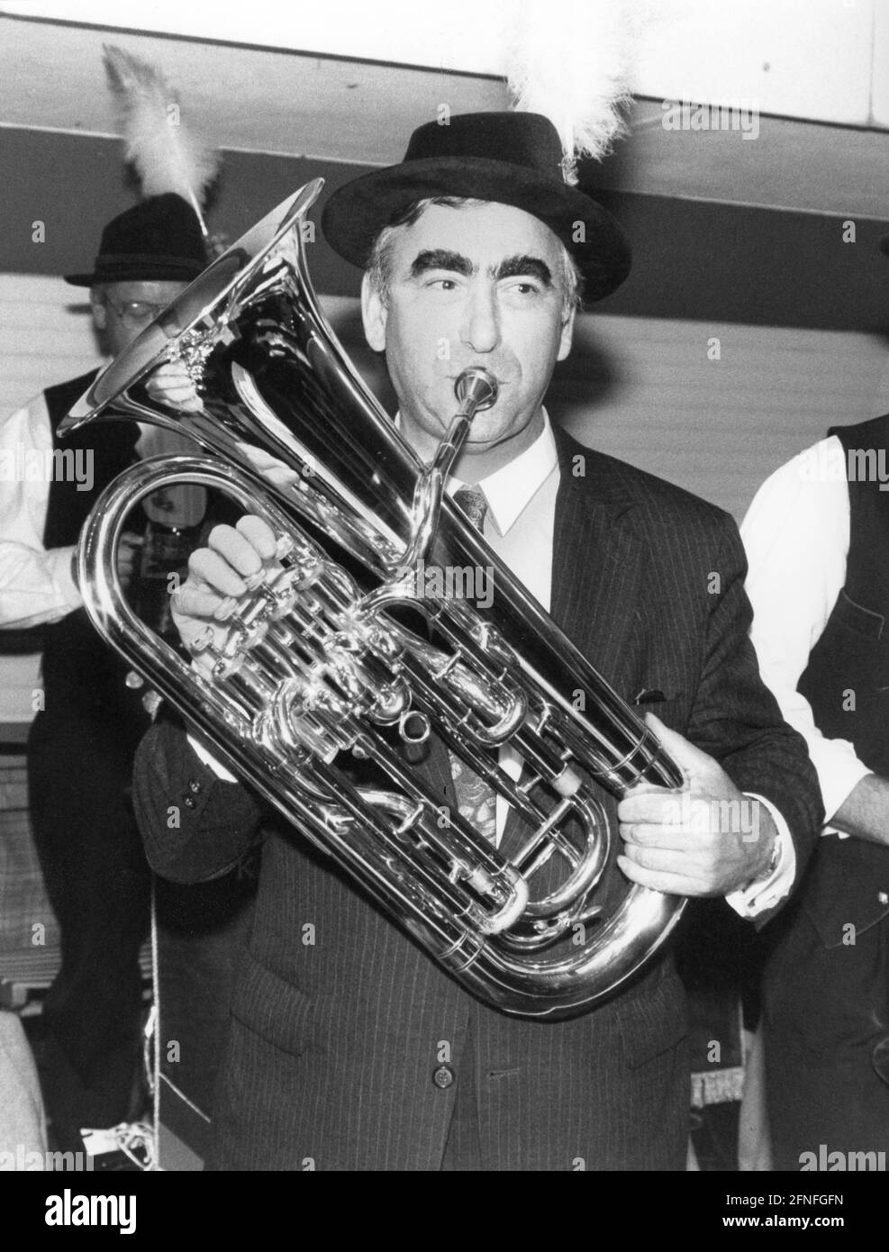Der deutsche Finanzminister und CSU-Vorsitzende versucht sich beim Start des Oktoberfestes in der Bayerischen Landesvertretung in Bonn die Tuba zu spielen. Undatierte Fotografie, ca. 1990. [Automatisierte Übersetzung] Stockfoto